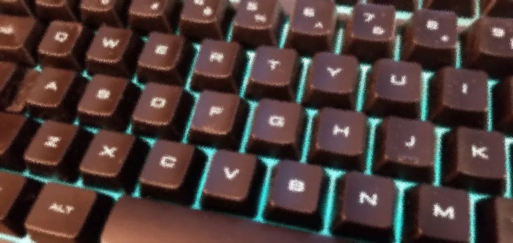 My keyboard, stylistically distorted purely for artistic effect, not at all to mask the dust and dirt that showed up because of the side lighting angle.
