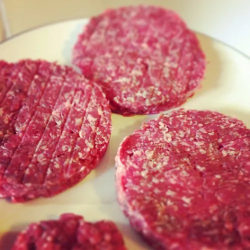 Raw hamburger patties ready to cook